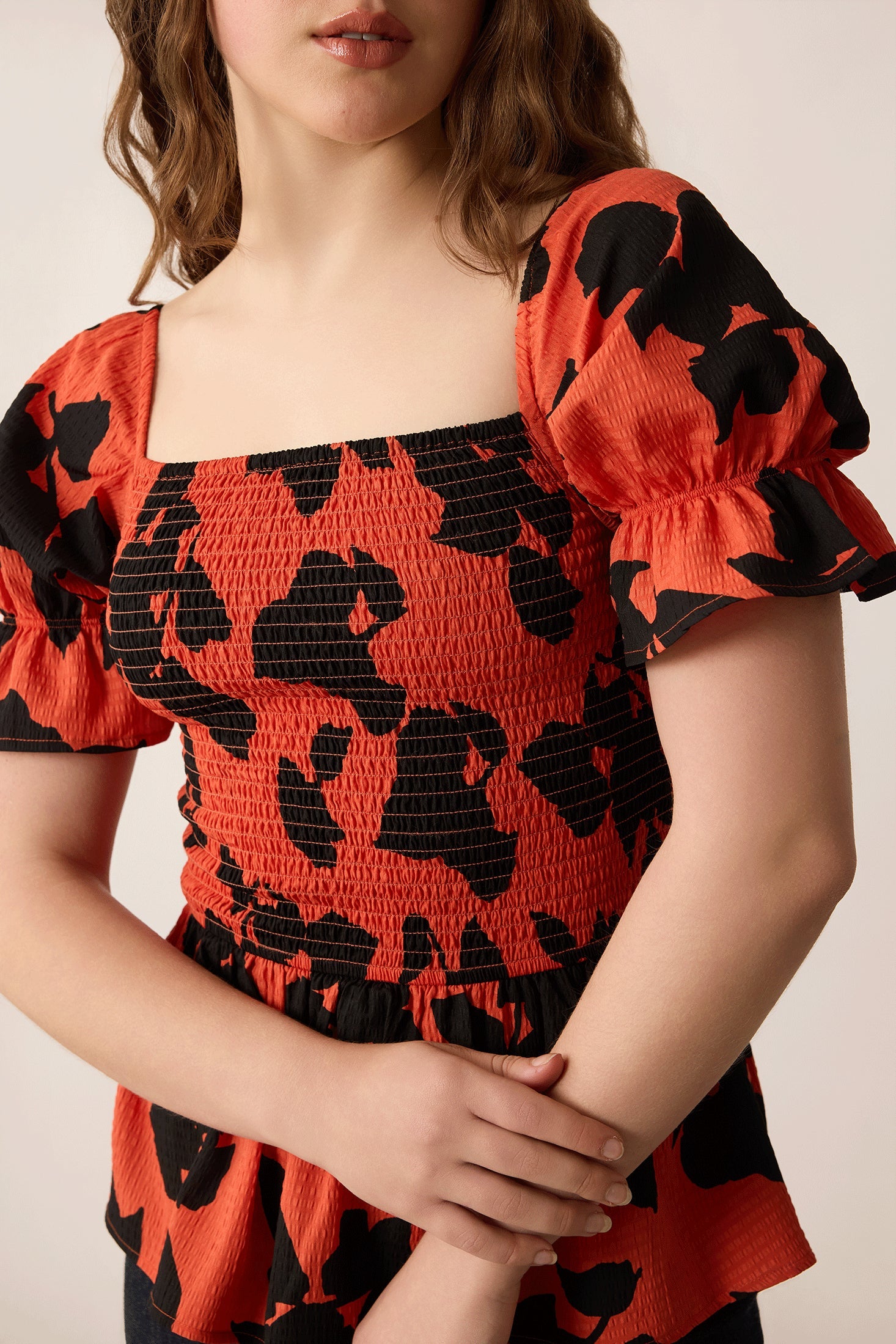 Bailey in Bold Peplum Top In Orange and Black